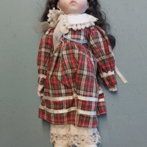 Porcelain doll on stand